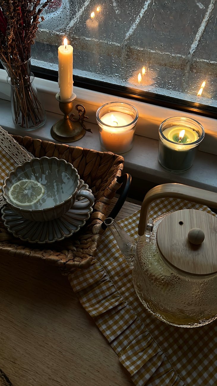 cozy indoor setting with candles and tea